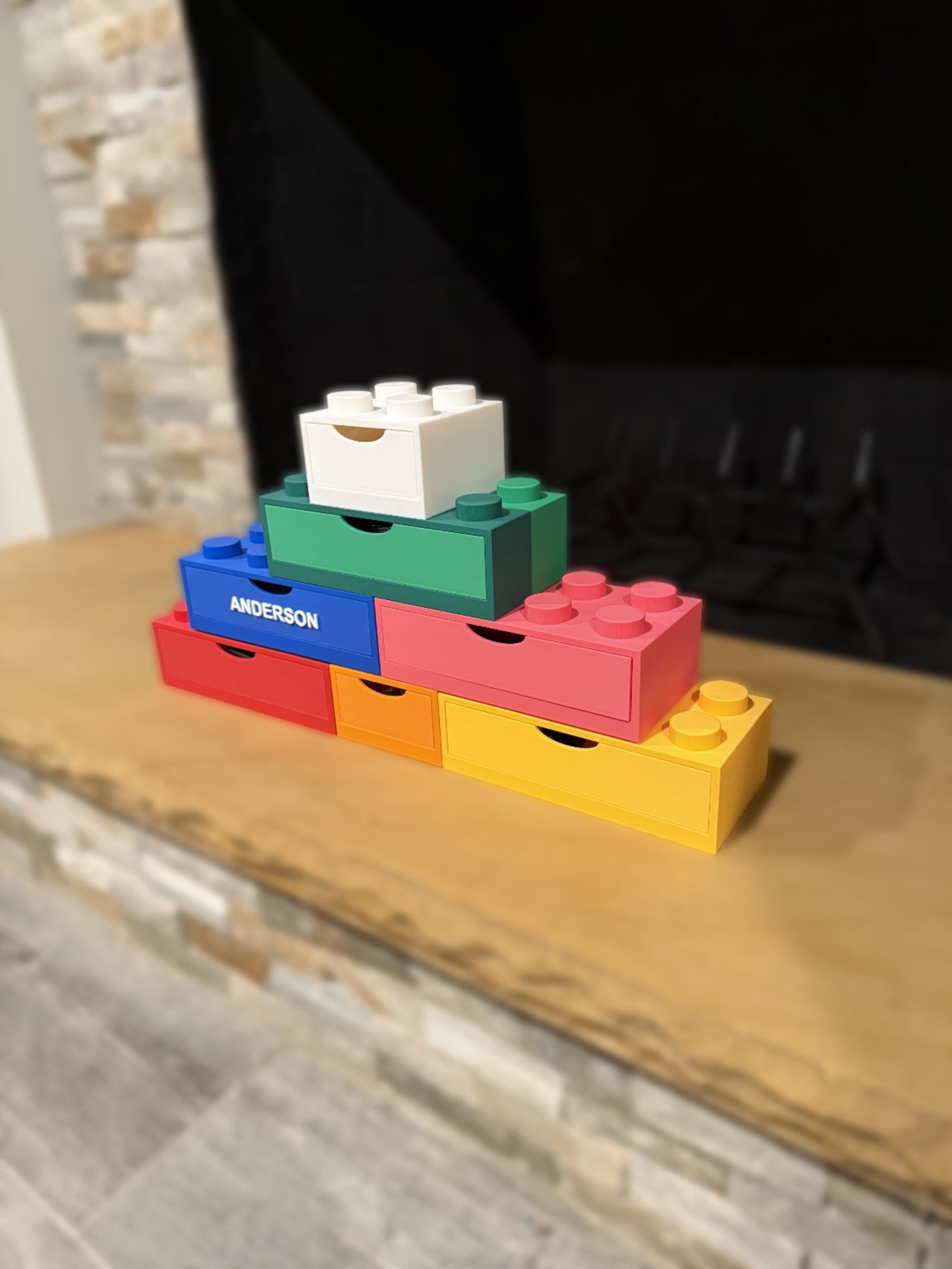 Stackable brick drawer organizer set built into a pyramid on a wood mantel